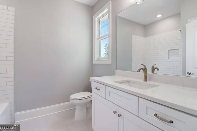 bathroom featuring vanity, tile patterned flooring, and toilet