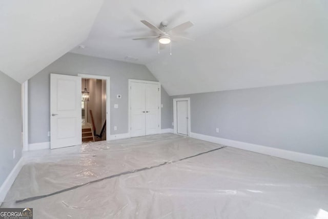 additional living space featuring vaulted ceiling and ceiling fan