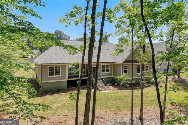 view of front of property with a wooden deck and a front lawn