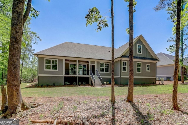 rear view of property with a yard