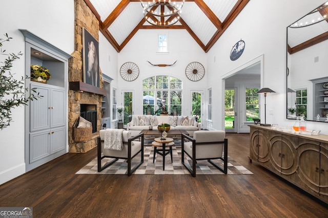 222 Valley View Dr, Rockmart, GA 30153 - living area with beamed ceiling, a stone fireplace, baseboards, high vaulted ceiling, and dark wood-type flooring