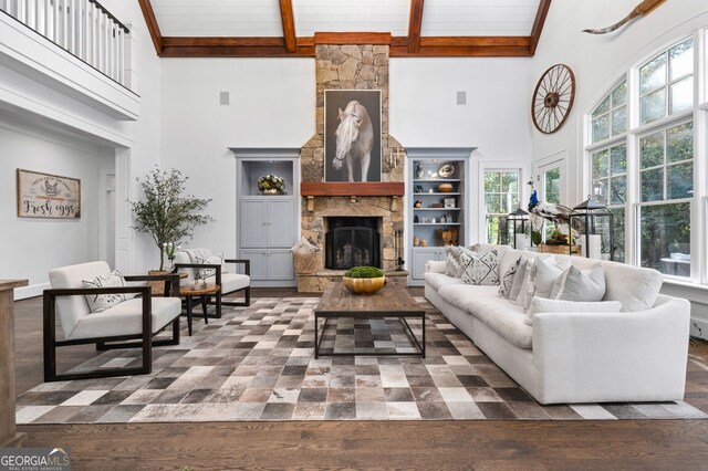222 Valley View Dr, Rockmart, GA 30153 - living area featuring beamed ceiling, a wealth of natural light, a stone fireplace, and a towering ceiling