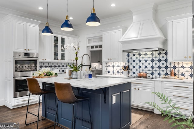 222 Valley View Dr, Rockmart, GA 30153 - kitchen with double oven, tasteful backsplash, white cabinets, a kitchen island, and premium range hood