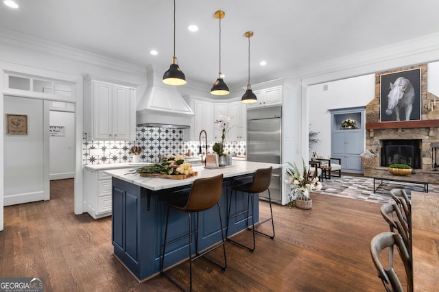 222 Valley View Dr, Rockmart, GA 30153 - kitchen with crown molding, custom exhaust hood, stainless steel built in fridge, backsplash, and white cabinets