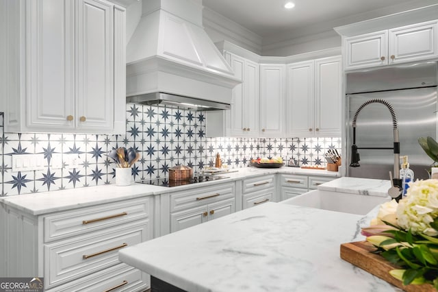 222 Valley View Dr, Rockmart, GA 30153 - kitchen featuring black electric stovetop, tasteful backsplash, custom exhaust hood, light stone counters, and white cabinetry