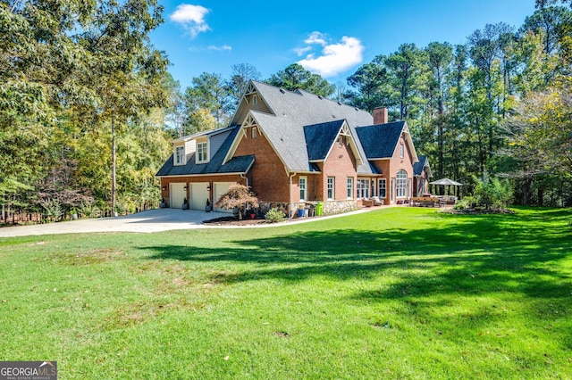 222 Valley View Dr, Rockmart, GA 30153 - tudor-style house featuring a chimney, brick siding, a garage, a front yard, and concrete driveway