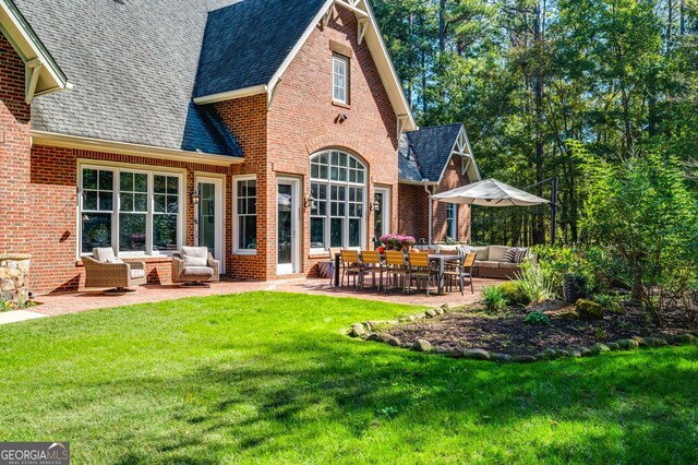 222 Valley View Dr, Rockmart, GA 30153 - rear view of house featuring outdoor lounge area, brick siding, a lawn, and roof with shingles