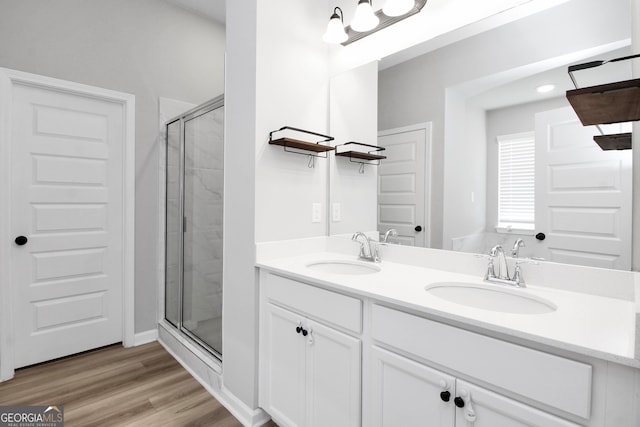 bathroom with vanity, hardwood / wood-style floors, and an enclosed shower