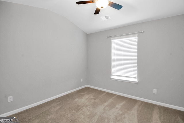 empty room with ceiling fan, carpet flooring, and lofted ceiling