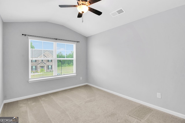 unfurnished room featuring ceiling fan, carpet, and vaulted ceiling