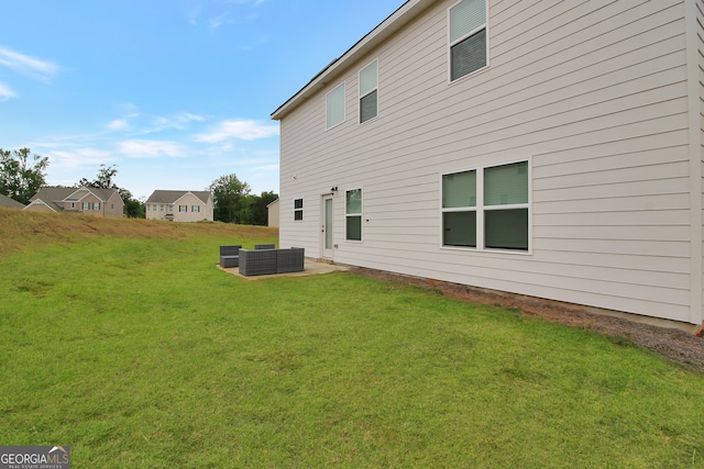 back of property with a patio and a lawn