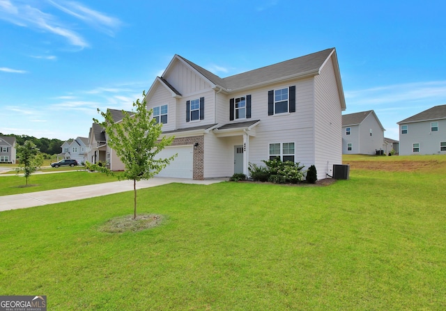 view of front of property with a front yard, central AC unit, and a garage