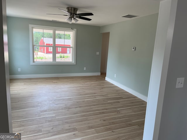 unfurnished room with ceiling fan and light hardwood / wood-style floors