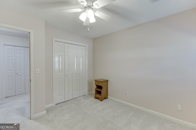 bedroom with light carpet, a textured ceiling, a closet, and ceiling fan