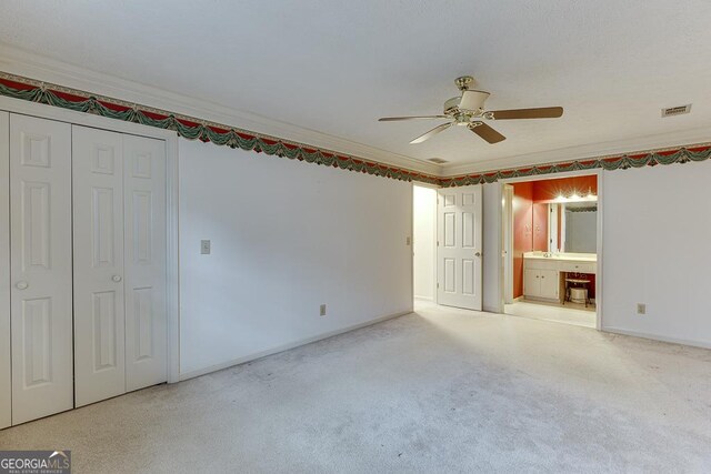 carpeted bedroom with a closet, ceiling fan, and a textured ceiling