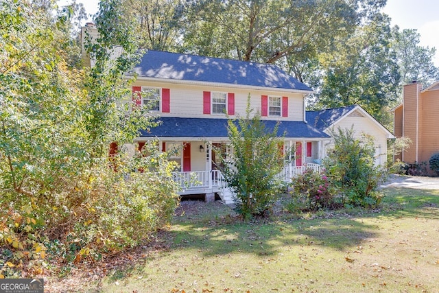 view of front of home featuring a front yard and a porch