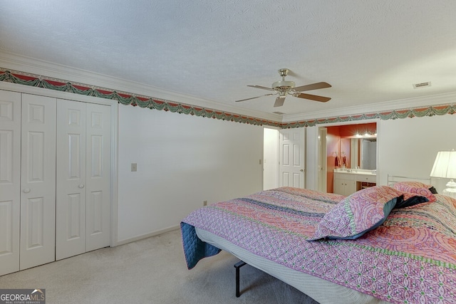 bedroom with ceiling fan, light carpet, ornamental molding, and a textured ceiling