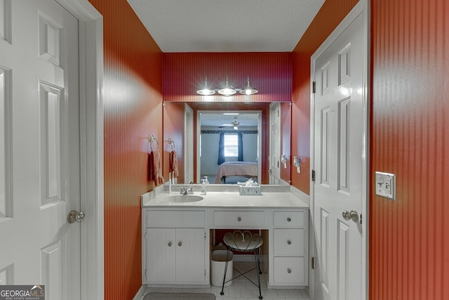 bathroom featuring vanity, a textured ceiling, and tile patterned floors