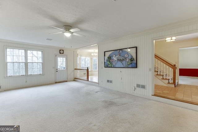 unfurnished living room featuring crown molding, carpet floors, and visible vents