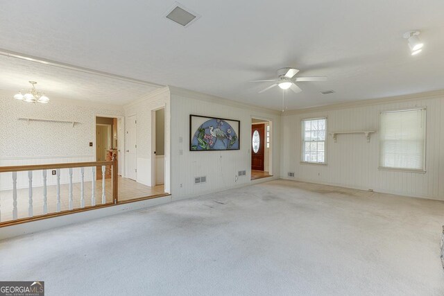 unfurnished room featuring a notable chandelier, carpet flooring, a textured ceiling, and ornamental molding