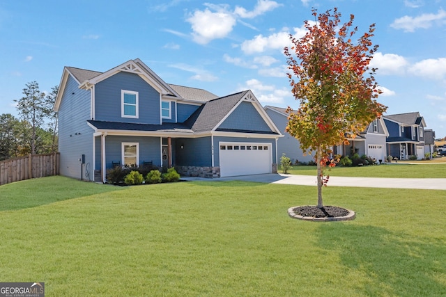 craftsman house featuring a front yard and a garage