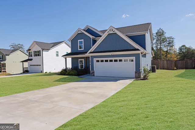 craftsman house featuring a front lawn, central AC unit, and a garage