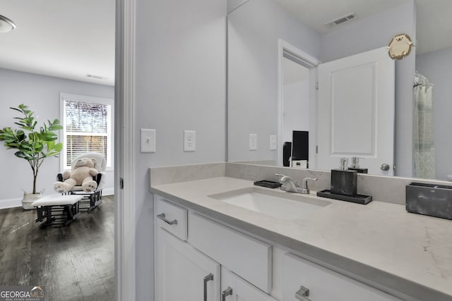 bathroom featuring vanity, hardwood / wood-style flooring, and walk in shower