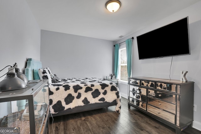 bedroom featuring dark hardwood / wood-style flooring