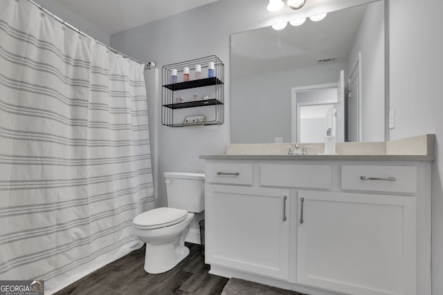 bathroom with vanity, wood-type flooring, toilet, and walk in shower