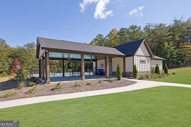 view of property's community featuring a yard and a swimming pool