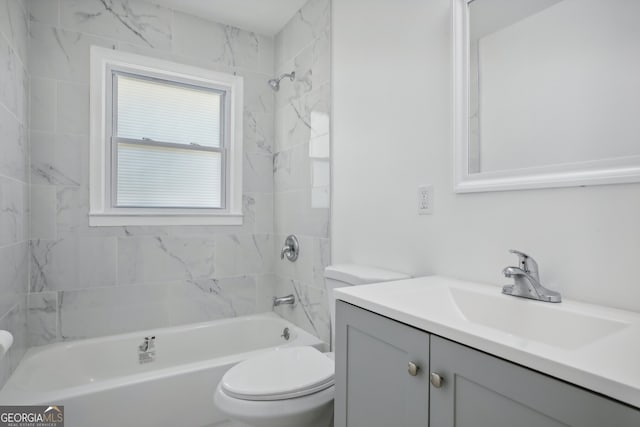 full bathroom with tiled shower / bath combo, vanity, and toilet