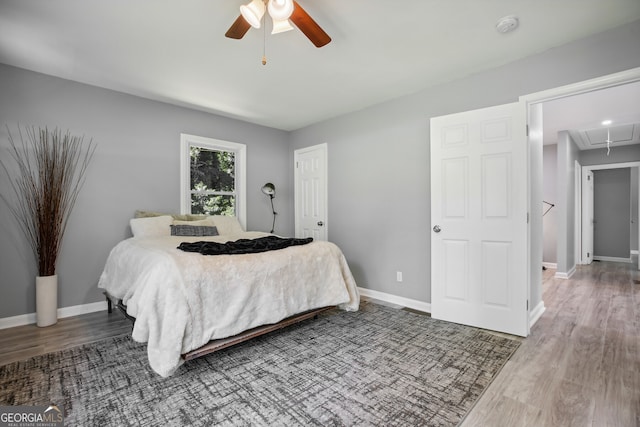 bedroom featuring hardwood / wood-style flooring and ceiling fan