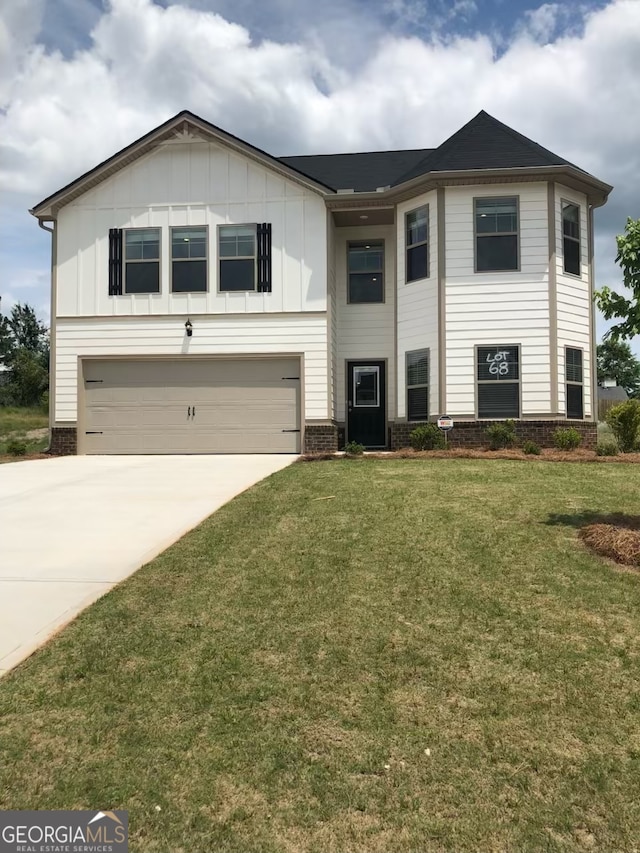 view of front of house featuring a front yard and a garage