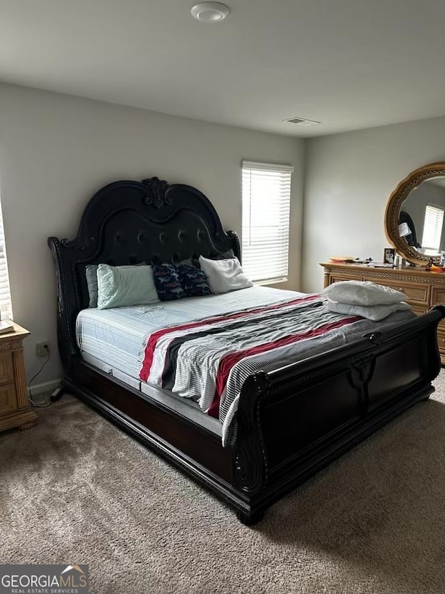 bedroom featuring carpet floors and visible vents