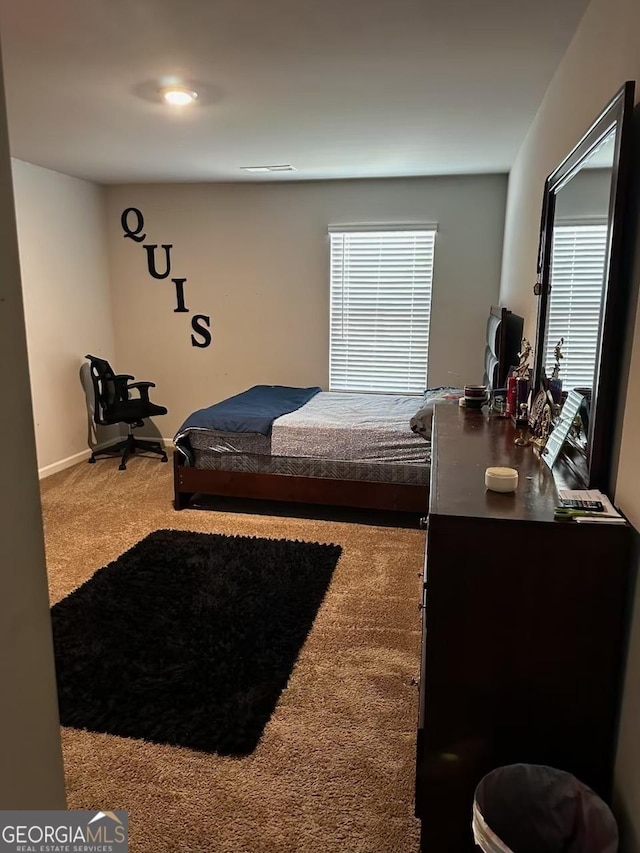 carpeted bedroom featuring baseboards