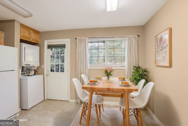 dining room with light tile patterned floors and stacked washer and clothes dryer