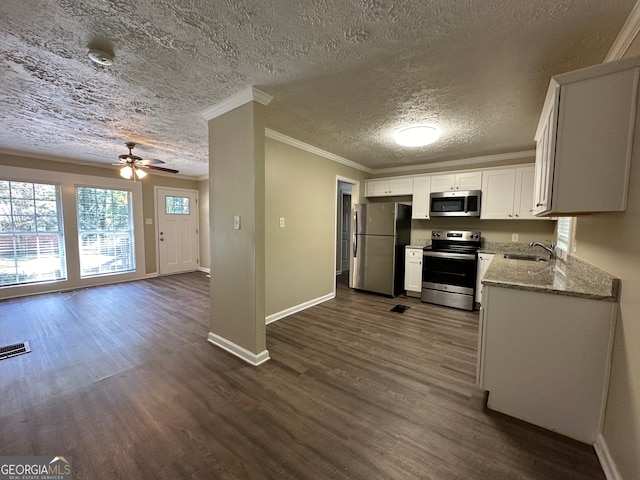 kitchen featuring light stone countertops, appliances with stainless steel finishes, a textured ceiling, dark hardwood / wood-style flooring, and white cabinetry