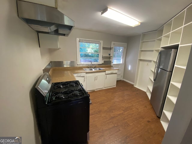 kitchen with sink, white cabinetry, black range with gas stovetop, stainless steel fridge, and dark hardwood / wood-style flooring