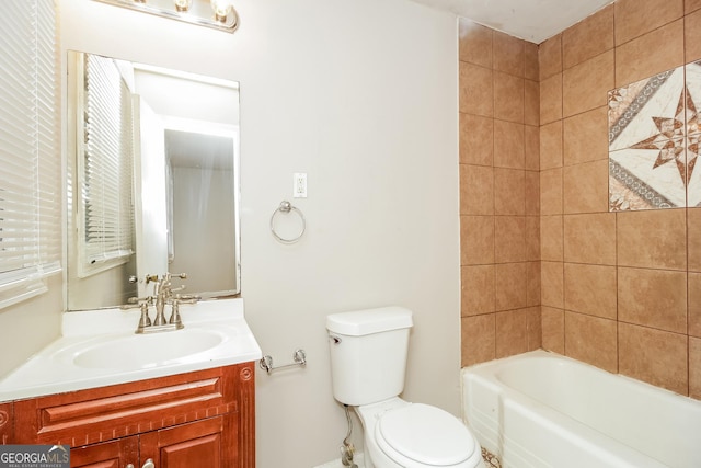 full bathroom with tiled shower / bath combo, vanity, and toilet