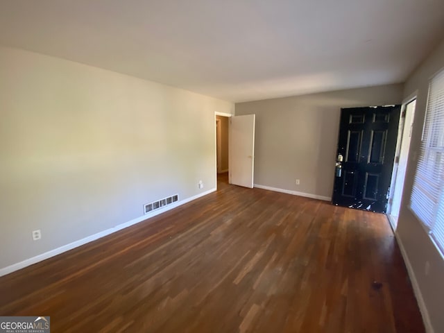 empty room featuring dark wood-type flooring