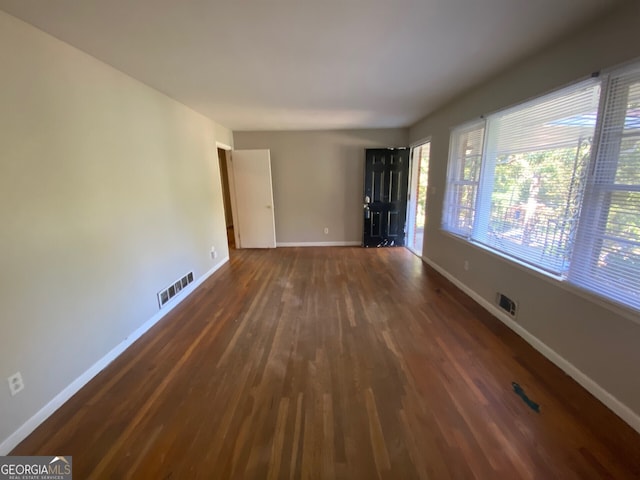 spare room featuring dark hardwood / wood-style flooring