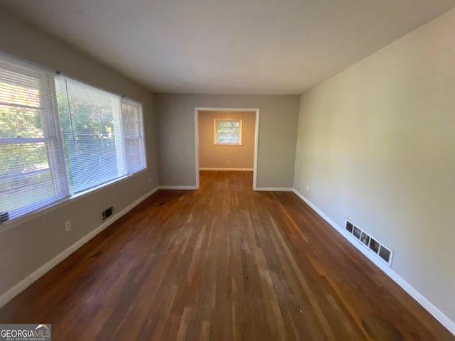 empty room featuring dark hardwood / wood-style flooring