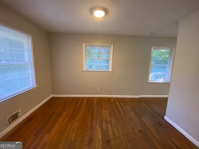 empty room with dark hardwood / wood-style floors