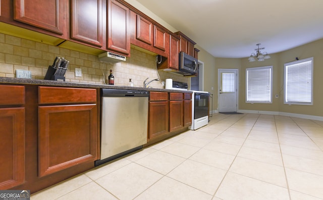 kitchen featuring backsplash, light tile patterned floors, stainless steel appliances, and an inviting chandelier