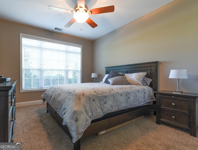 bedroom with ceiling fan and dark colored carpet