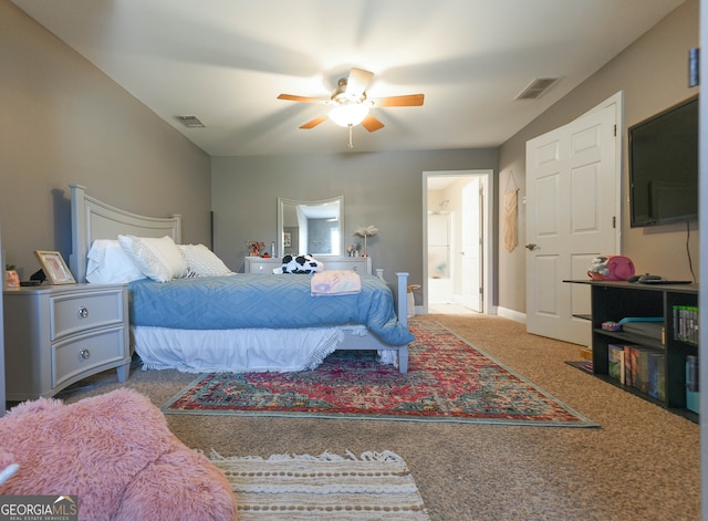 carpeted bedroom with ensuite bath and ceiling fan