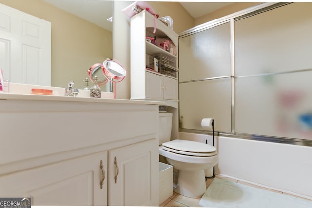 full bathroom featuring tile patterned flooring, vanity, bath / shower combo with glass door, and toilet