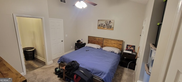 bedroom featuring connected bathroom, ceiling fan, and dark carpet