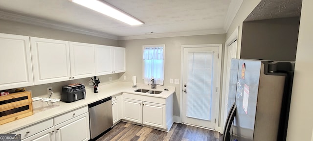 kitchen with dark hardwood / wood-style floors, ornamental molding, sink, stainless steel dishwasher, and white cabinetry