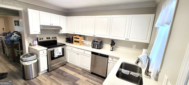 kitchen featuring ornamental molding, dark wood-type flooring, white cabinets, and stainless steel appliances